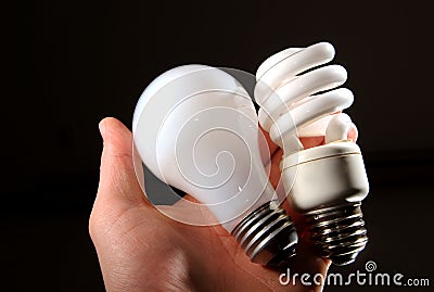 Incandescent and cfl lightbulb in human hand. Stock Photo