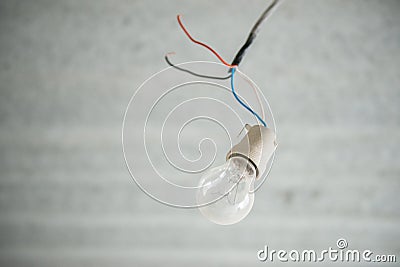 Incandescent lamp. obsolete light bulb on the ceiling in an empty apartment Stock Photo