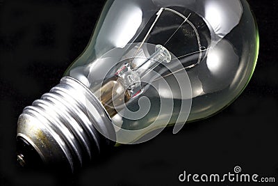 Incandescent light bulb on black Stock Photo