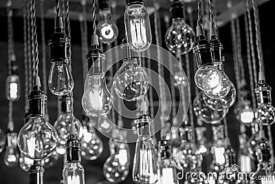 Incandescent Light bulb chandelier array hanging from the ceiling Stock Photo