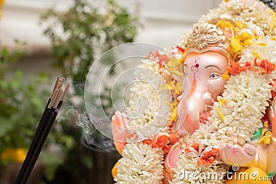 Incense or agarbatti sticks in front of lord vinayaka or Ganesha while worshiping during ganesha chaturthi or vinayaka Stock Photo