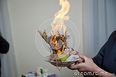 Incense of herb smokes for good luck. Magic plant uzerlik . Burning prevents bad looking . Peganum harmala Stock Photo