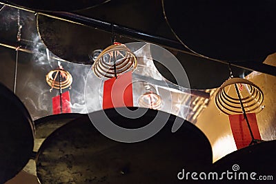 Incense spirals burning at the ceiling of Man Mo temple, Hong Kong, Asia Stock Photo