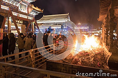 Incense sticks, joss-sticks, religion, Chinese, Hohhot burning outdoors at night Editorial Stock Photo