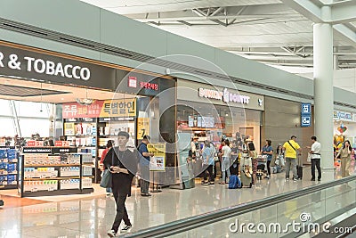 Tobacco tax free store and Dunkin Donuts fast food chain at ICN international airport Editorial Stock Photo
