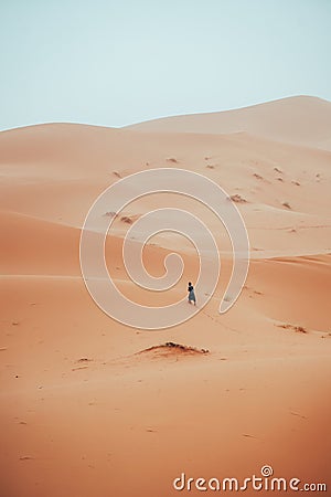 Incidental local berber man wandering through Sahara Desert Merzouga, Morocco Stock Photo