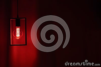 Included electric light bulb on the background of dark curtains, lamp Stock Photo