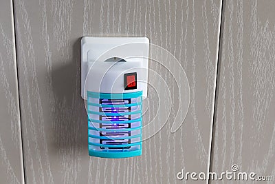 Included working fumigator electric in socket in wall to protect against mosquitoes Stock Photo