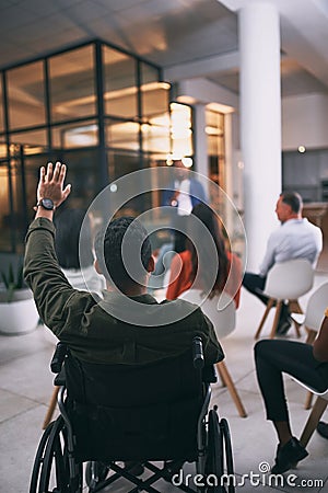 Inclusivity breaks all boundaries. an unrecognizable businessperson raising their hand to ask a question during a Stock Photo