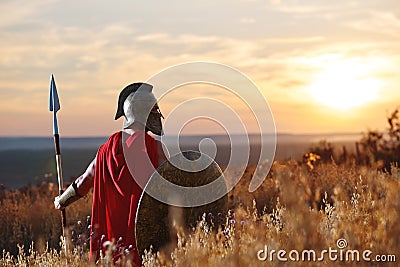 Incognito warrior in iron helmet and red cloak. Stock Photo