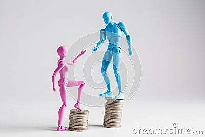 Income inequality concept shown with realistic male and female figurines and piles of coins. Stock Photo