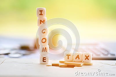 Income Tax Return Deduction Refund Concep / Tax words on jigsaw and calculator coins on invoice bill paper Stock Photo