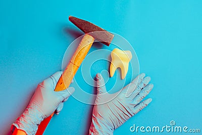 Unprofessional Dentist Holding a Hammer Hitting Tooth Stock Photo