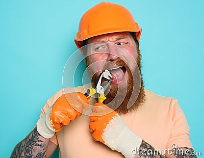 Incompetent worker acts like a dentist and removes a tooth. cyan background Stock Photo