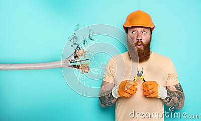 Incompetent worker electrician is unsure about his work. cyan background Stock Photo