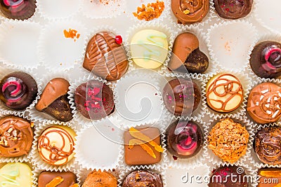 Incomplete box of delicious handmade chocolates Stock Photo