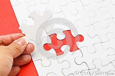 Incomplete puzzle with missing piece on human hand Stock Photo