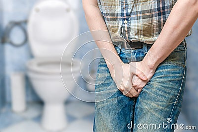 Incontinence concept. Man wants to pee and is holding his bladder Stock Photo