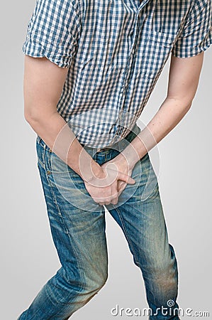 Incontinence concept. Man wants to pee and is holding his bladder Stock Photo