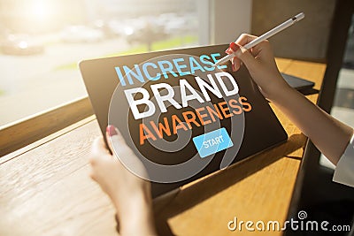 Increase brand awareness text on screen. Advertising and marketing concept. Stock Photo