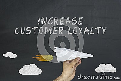 Increase customer loyalty concept on blackboard Stock Photo