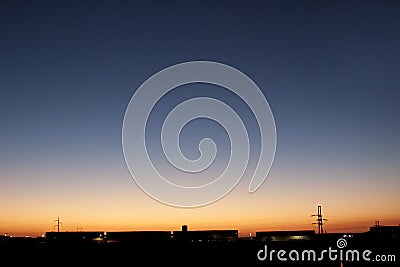 Incredible sunset behind factory and transport, freight and delivery company. Stock Photo