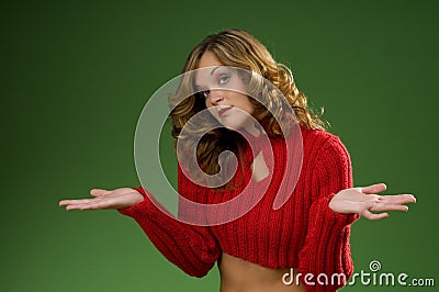 Indecisive woman on Christmas green background Stock Photo