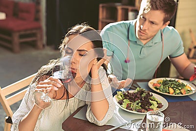 Independent long-haired girl turning away from her boyfriend Stock Photo