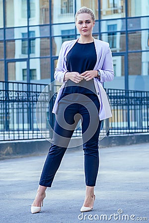 Independent strong and beautiful blonde woman business lady in a fashionable suit and high heels on the street Stock Photo