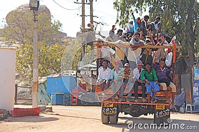 India, Hampi, 02 February 2018. A beautiful Indian truck carries a lot of Indian people. The merry Hindus smile and wave their Editorial Stock Photo