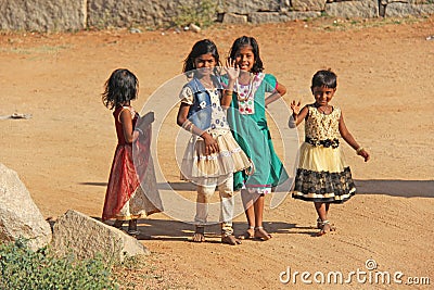 India, Hampi, 02 February 2018. Children of India, in Hampi. A group of Indian children in bright clothes and barefoot, stand and Editorial Stock Photo