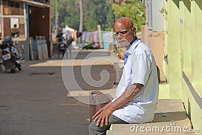 India, Hampi, February 2, 2018. An elderly Indian man, an old man with large white or gray eyebrows, sits. He wiped a man who was Editorial Stock Photo