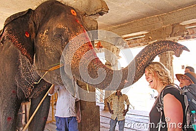 India, Hampi, 01 February 2018. Indian elephant in the Temple of Virupaksha blesses the girl for money Editorial Stock Photo
