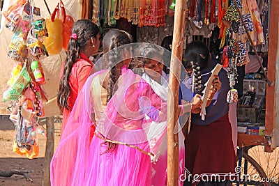 India, Hampi, 02 February 2018. Young girls in bright pink saris are buying something on the market Editorial Stock Photo