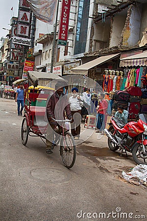 Rickshaw bike taxi in search of customers at the Main Bazaar Paharganj in Indian capital Editorial Stock Photo