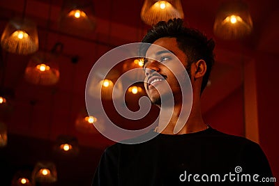 India student stang lighting diyas in dark room Stock Photo