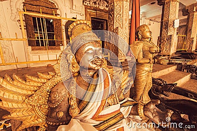 Indian art with metal Garuda sculpture inside traditional Hindu temple. Ancient artwork of India Stock Photo