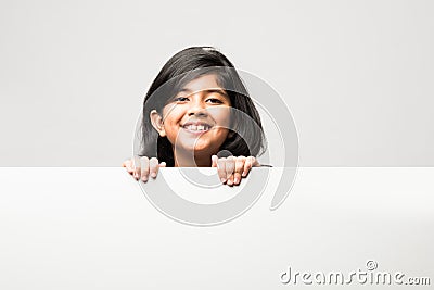 Indian asian cute little girl pointing at blank white board with grandpa or grandfather Stock Photo