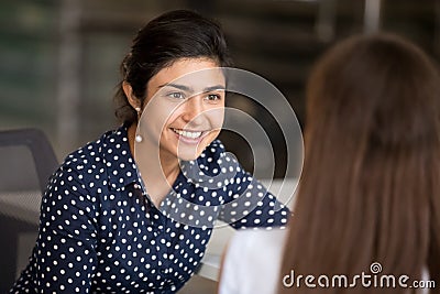 Little girl whispering in surprised grandmother ear, telling secret Stock Photo