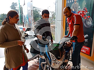 an indian automobile salesmen presenting bike model to the couple customer at showroom in India January 2020 Editorial Stock Photo