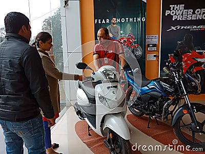 an indian automobile salesmen presenting Scotty model to the female customer at showroom in India January 2020 Editorial Stock Photo