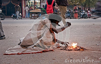 Indian beggar at street in winter Editorial Stock Photo