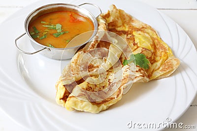 Indian bread or Roti telur with curry sauce Stock Photo