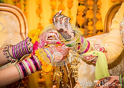 Indian bride hands getting decorated. Stock Photo