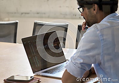 Indian business man analyzing stock market crypto trading chart. Stock Photo