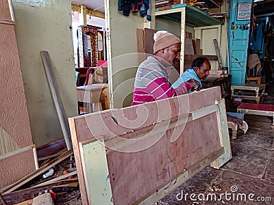 an indian carpenter making wooden furniture at workshop in india January 2020 Editorial Stock Photo
