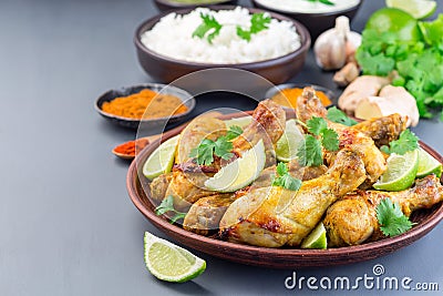 Indian chicken tandoori, marinated in greek yogurt and spices, served with lime wedges and cilantro, horizontal, copy space Stock Photo