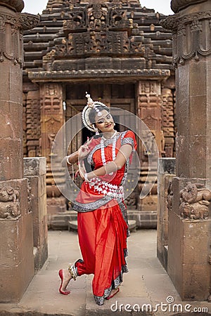 Indian classical dance.Beautiful Odissi dancer posing at mukteshwar temple Stock Photo