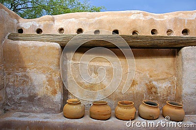 Indian clay pots on adobe wall. Stock Photo