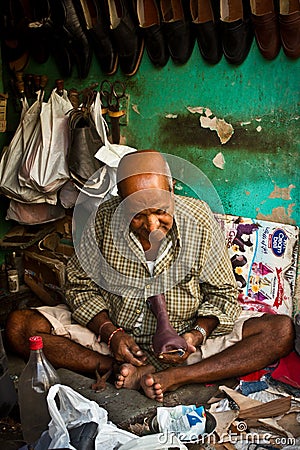 Indian cobbler at work, Delhi, India Editorial Stock Photo